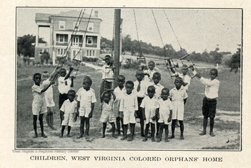 Children of the West Virginia Colored Orphan's Home in Huntington, Cabell County, West Virginia are playing on swings.