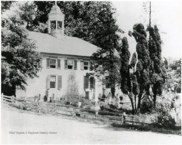 Old stone church with wooden shutters with a graveyard in front of it, Lewisburg, W. Va.