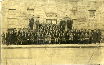 A group of people posing in front of an unidentified Christian Church in Lewisburg, West Virginia.