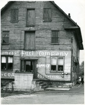 Man walking outside of a fuel company office building, Martinsburg, W. Va.