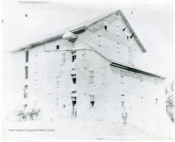 People looking at doorways of a large building in Martinsburg, W. Va.