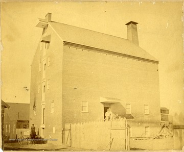 Man standing at the doorway of Grist Mill in Martinsburg, W. Va.