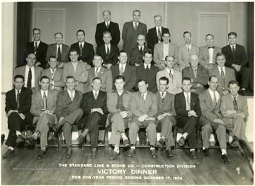 Group portrait of Thirty-one men gathered for The Standard Lime and Stone Co., Construction Divison Victory Dinner.  