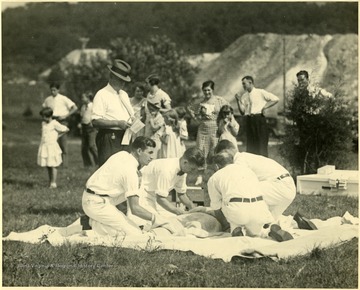 Four men working in a group at a mine safety meet, Martinsburg, W. Va.