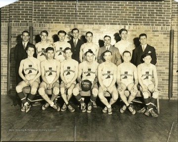 Team picture of the Interwoven Mills basketball team.  The basketball reads "Champs 30-31."  Martinsburg, W. Va.