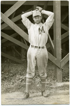 Man is striking a pose like he is ready to throw.