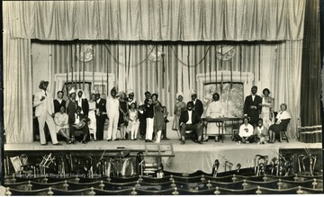 Group of people in make-up pose on the stage.