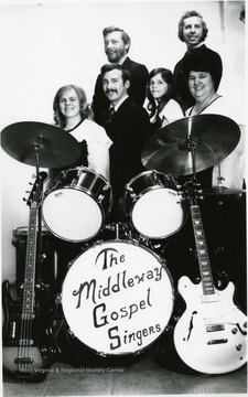 Group portrait of the singers and their instruments.