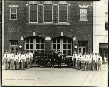 Members of Fire Department Hose Company No. 3 of Martinsburg, West Virginia pose for a group portrait in front of their firehouse.