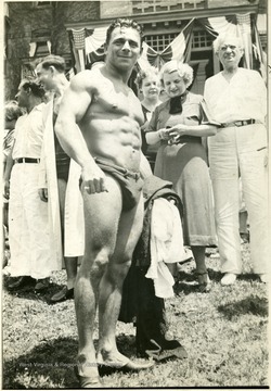 A muscular man standing with a crowd, Martinsburg, W. Va.