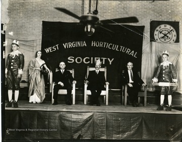 Members of the West Virginia Horticultural Society sit on a stage during the Apple Blossom Festival in Martinsburg, West Virginia.