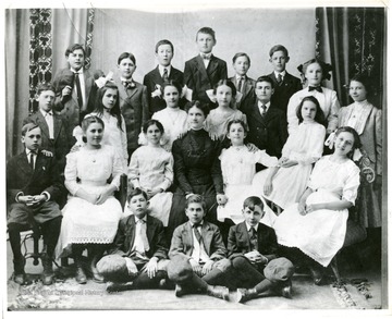 Large group portrait of a woman and children (boys and girls), Martinsburg, W. Va.