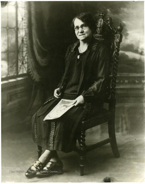 Lady sitting in a chair, possibly Dr. Evers.