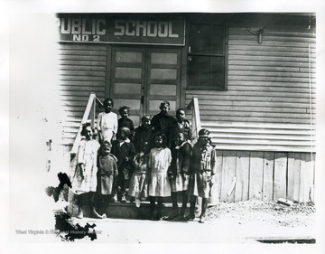 Children of  Public School No. 2., an African-American school in Nitro, pose on the front steps of the school house for a group portrait.