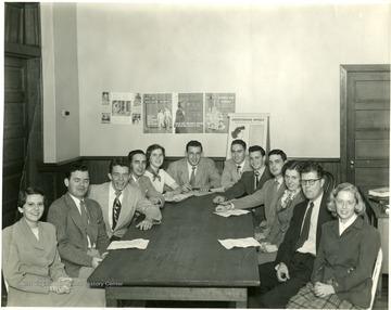 Group of unidentified men and women sitting around a table for a presentation entitled 'Discovering Myself,' Martinsburg, W. Va.
