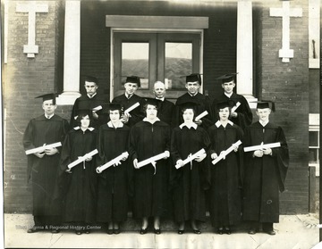 St. Joseph's graduates standing on stairs holding their diplomas, Martinsburg, W. Va.