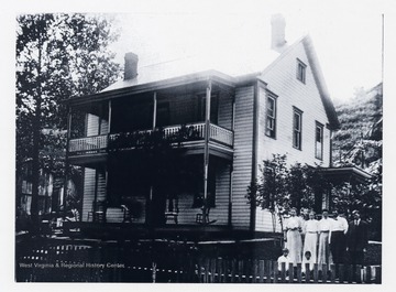 'Samuel Mullett's Home Built in 1894, Doolin Run, Wetzel County, West Virginia. Left to Right-Eunice Cross, Emma Cross, Bertha Mullett, William Mullett, Harry Mullett. Front: Jesse Mullett, Wilbert Kocher.'