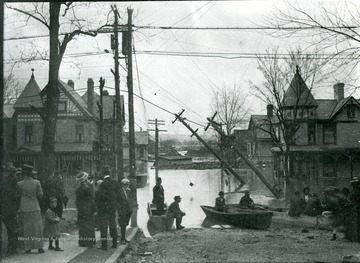 Flooded street. Rescue boats and people gathered by flooding waters near downed power lines, Parkersburg, W. Va.
