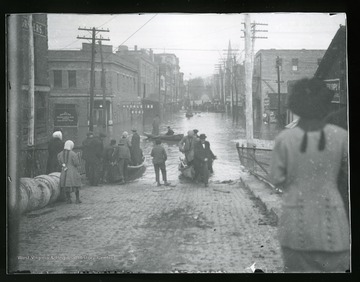 Townspeople are pushing their boats down an unidentified street in Parkersburg, West Virginia during the flood of 1913.