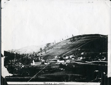 A rural scene of a church and houses from an unknown city. 