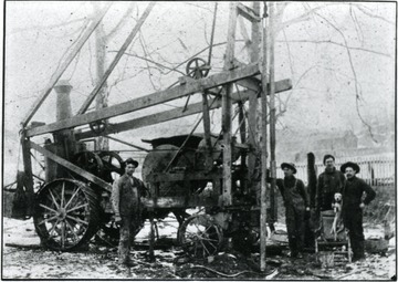 Men stand next to a drilling machine in Weston, W. Va.