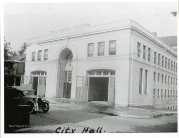 A girl is crossing the street from the City Hall Building in Morgantown, West Virginia.