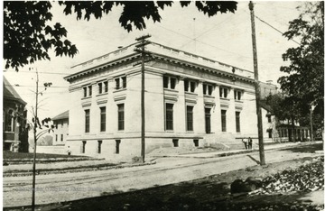 'Post Office, Morgantown, W. Va. Corner of Kirk and High Street.  The Geo. C. Sturgiss home was behind P.O.  The Chadwick home to the right of the P.O.  The Presbyterian Church to the left of the P.O.'