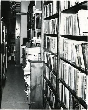 Shelves of books through an aisle at the Waitman Barbe public library. 