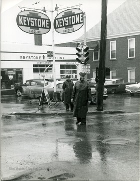 Two police officers standing on the corner of Spruce and Pleasants Streets (Lt. Oscar Clingan front, Ch. John Lewis back.)  Morgantown, W. Va.