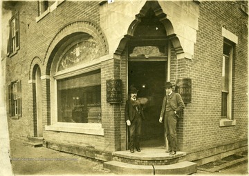 Men standing in front of Company building in Morgantown, W. Va. 