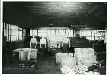 Interior view of Morgantown Printing and Binding business at their 'new location at the corner of Kirk and Chestnut.  Left to Right:  Milford Trickett, Raymond Ludwig, and Glenn (Red) Dettner.'