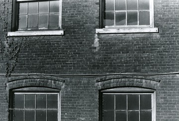 'Detail of window casements along the Railroad tracks. View facing west. Windows of original Woolen Mill portion of building.' 