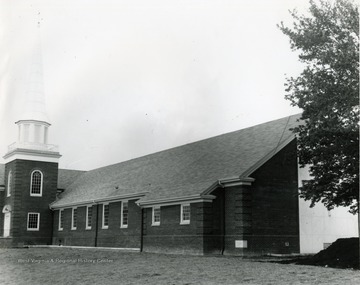 Exterior view of Drummond Chapel, located in Morgantown, W. Va. Steeple seen topped with a cross. 