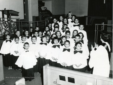 Instructor seen to the right of the choir. 