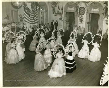 People are dancing The Riley. A dance featured each year during the Lee Ball (Lee Week) at the Greenbrier, White Sulphur Springs, West Virginia.
