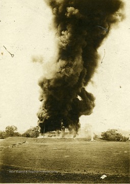 Oil tank fire located in Morgantown, W. Va. Smoke rolling from fire.