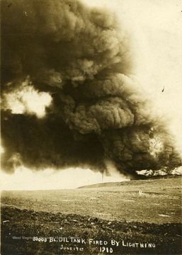 30,000 Barrel Oil tank fire triggered by lightning in Morgantown, W. Va. Smoke fills the sky. 