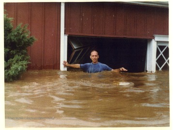 Bobby Riley is wading through the flood at Morgan Shirt Factory in Morgantown, West Virginia.