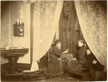 Laura and Jessie Burt play cards at their home on South Pennsylvania Street, Wheeling.