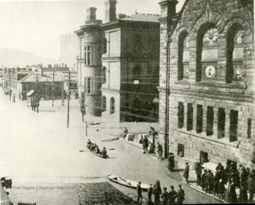 16th Street, showing Post Office and English Lutheran Church, Flood of March  1907 Ohio River at Wheeling, W. Va. People are seen using boats to get through town over flood waters. 