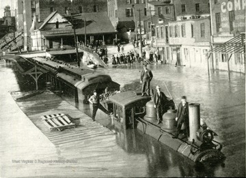 'Pennsylvania Railroad Depot Showing Passanger Train, flood of March 1907, Wheeling, W. Va.' Water can be seen at least half way up the train. 