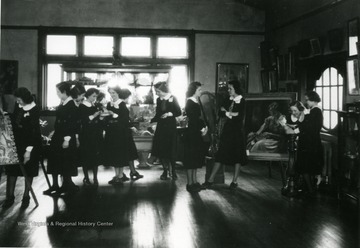 Women seen standing inside of the  Mt. De Chantal Academy Art studio showroom. 