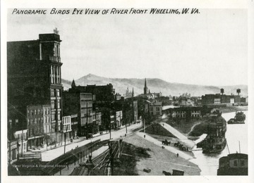 A picture postcard of the River Front in Wheeling, West Virginia. River boats at the Wharf on the Ohio River.