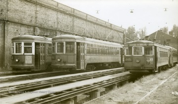 Three Cooperative Transit cars are seen on the tracks. 