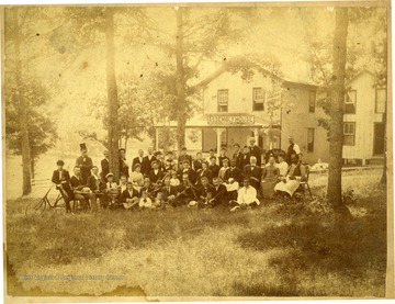 'Dr. Alex Wade in back, tall old man with beard.  First row next to colored man, right to left; Walter Mestiogal, unknown, Russ Hinton, Charles L. Johnston started band.