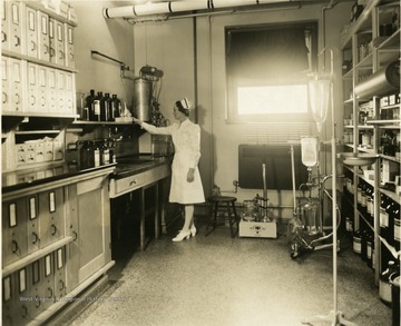 Nurse 'Miss Adamovich, RN' in the Monongalia General Hospital's Pharmacy. Located in Morgantown, W. Va. 