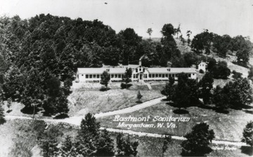 Exterior view of the Eastmont Sanitarium located in Morgantown, West Virginia. Road leading to the Sanitarium seen running up the hill. 