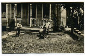 'Left, holding 'Darby', Samuel G. Hackney.  Being butted, Glenn Hackney.  Seated on porch, James Henry Krepps.'