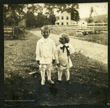'James Henry Krepps, 'looking pretty', and Frank Morgan at Old Mill Cottage at Cheat.  Shaffer home in background.  All are now covered by Cheat Lake.'