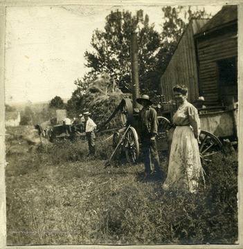 'Threshing farm of James L. Krepps, The Flatts, Morgantown, W. Va.  Man with stiff straw hat, white shirt is John H. Krepps, son of James L.  Woman is Mrs. John H. Krepps, mother of James Henry Krepps.'